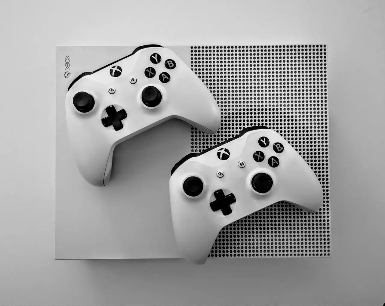 To hvide Xbox-controllere på en spillekonsol